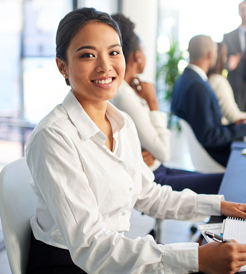 Woman taking notes during meeting