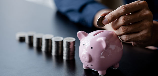 Putting money in piggybank