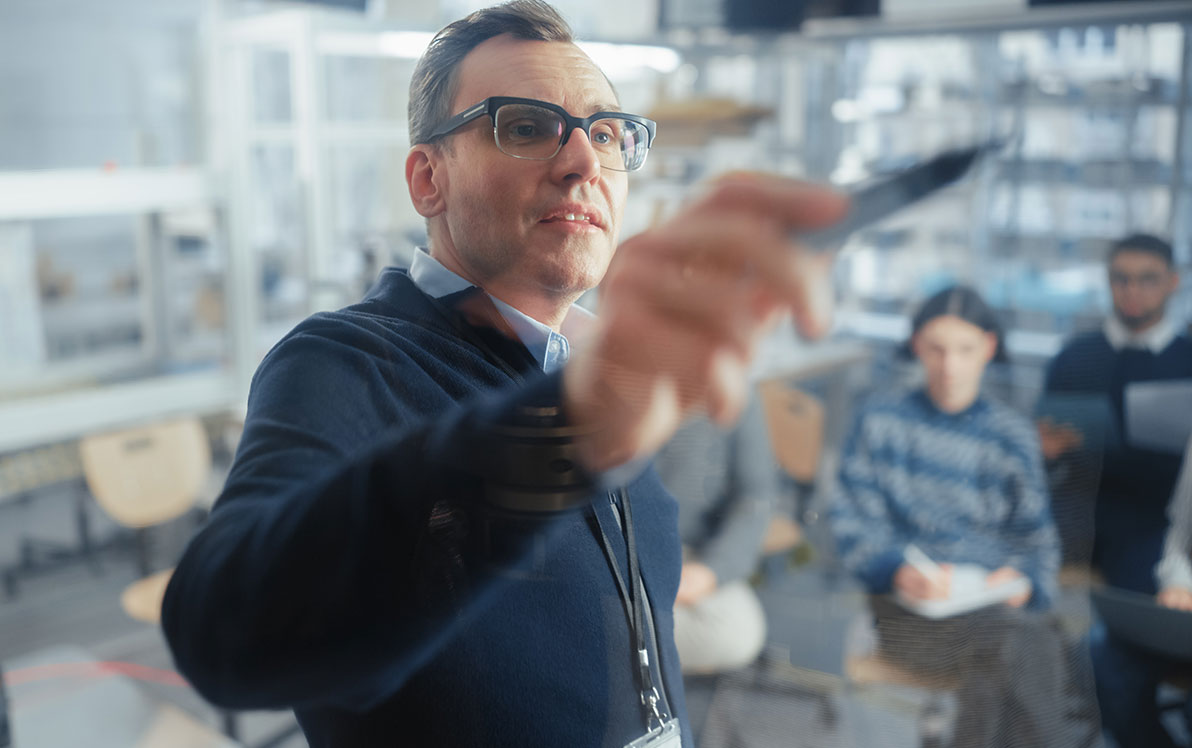 Study coordinator using pen to point to board in lab
