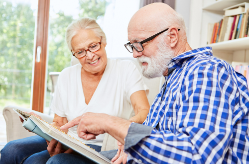 Senior couple reading from a book, representing precision medicine in Alzheimer's Disease clinical research