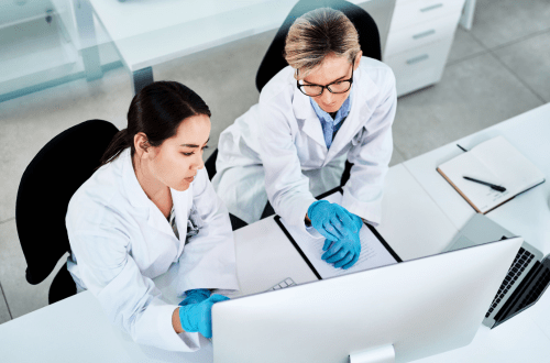 Two female clinicians at a computer representing TMF capabilities in clinical trials